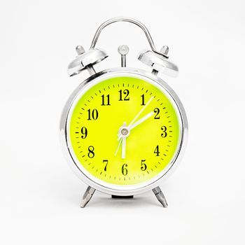 Alarm clock on white background. Showing time ten minutes past six