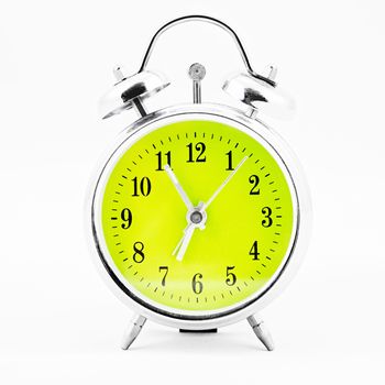 Alarm clock on white background. Showing time five minutes before seven