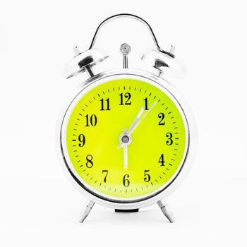 Alarm clock on white background. Showing time five minutes past six