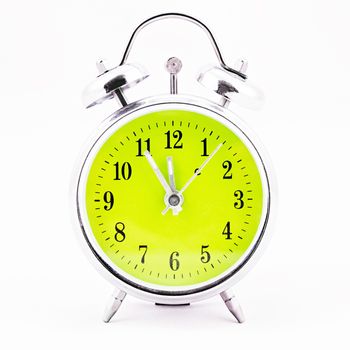 Alarm clock on white background. Showing time five minutes before twelve