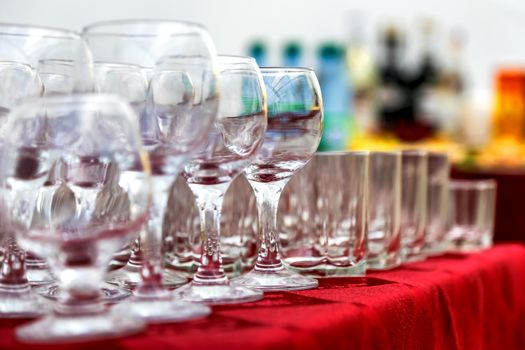 Empty wine glasses composition on table before celebration at outdoor