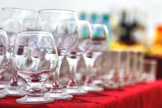 Empty wine glasses composition on table before celebration at outdoor