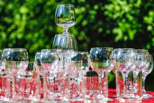 Empty wine glasses composition on table before celebration at outdoor