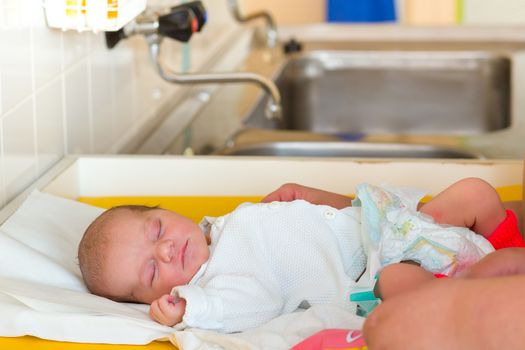 sleeping newborn baby in the hospital - the first hours of the new life