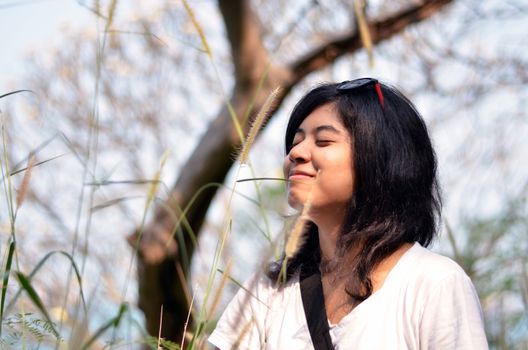 Young asian woman breathing fresh air in garden