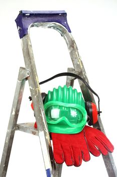 Safety gear kit on step ladder over white