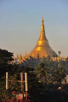 Shwedagon Pagoda Temple with village below in the morning light at Yangon, Myanmar (Burma)