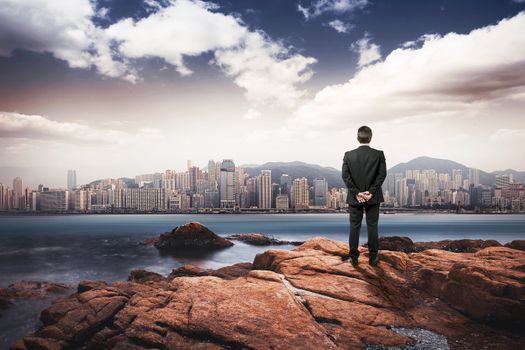 manager watching city from rocks island