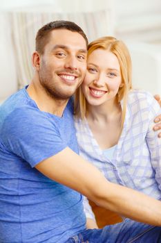 love, family and happiness concept - smiling happy couple at home