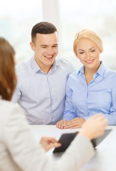 finance, bank, family and business concept - smiling couple at bank