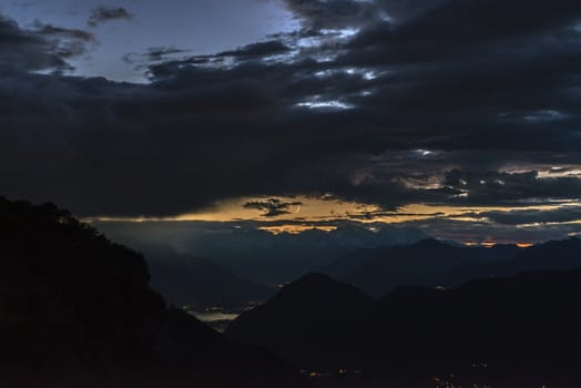 Moonsets over Alps in a cloudy evening