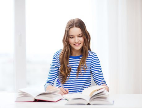 education and home concept - happy smiling student girl with books