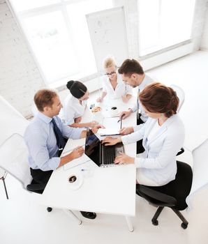 business concept - friendly business team having meeting in office