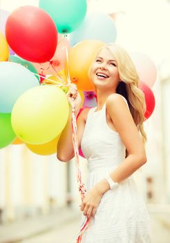 summer holidays, celebration and lifestyle concept - beautiful woman with colorful balloons in the city