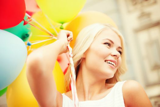 summer holidays, celebration and lifestyle concept - beautiful woman with colorful balloons in the city