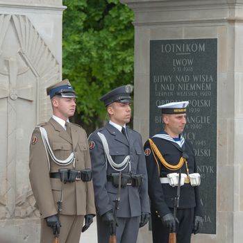 Warsaw, Poland – May 12, 2014: Honor guard at the Tomb of the Unknown Soldier. The monument  is the most important element of the Pilsudski Square, was built-up in a preserved colonnade of the Saxon Palace which was destroyed during the WW II.