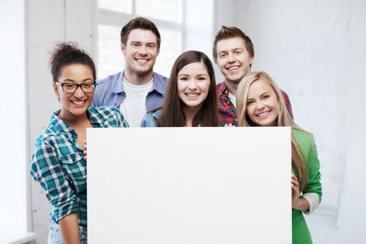 education concept - group of students at school with blank white board