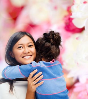 family, children and happy people concept - hugging mother and daughter