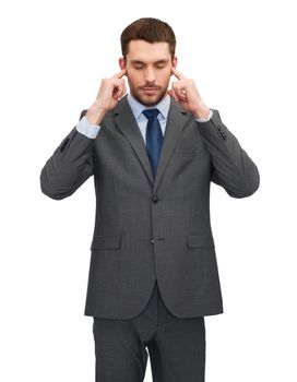 businss, office and education concept - annoyed businessman covering his ears with his hands