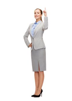 business and education concept - attractive young businesswoman with her finger up