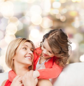 family, child and happiness concept - hugging mother and daughter