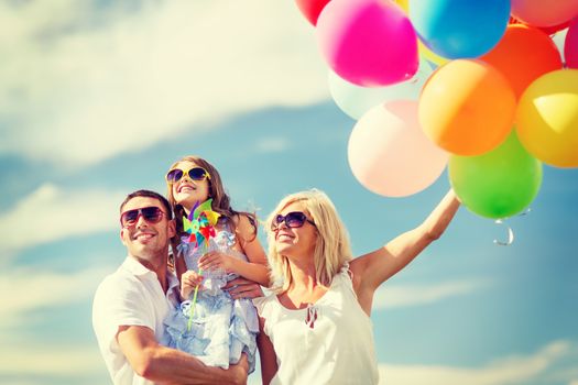 summer holidays, celebration, children and people concept - family with colorful balloons