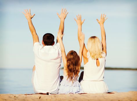 summer holidays, celebration, children and people concept - happy family at the seaside with greeting gesture