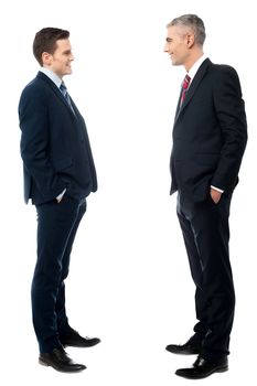 Businessmen conversation together, hands in pockets