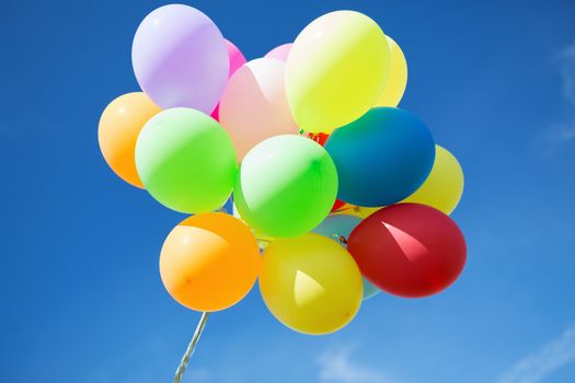 balloons and celebration concept - lots of colorful balloons in the sky