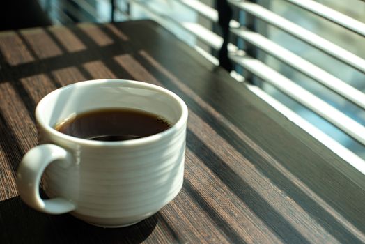 Hot Coffee cup on table near windows