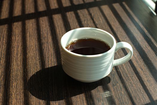 Hot Coffee cup on table near windows