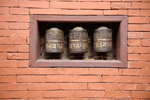 prayer wheels in the beautiful golden temple in patan, nepal
