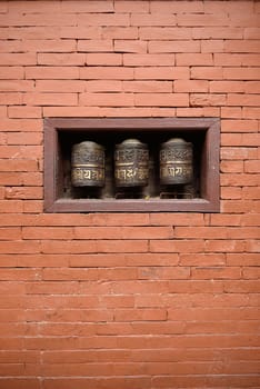 prayer wheels in the beautiful golden temple in patan, nepal