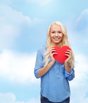 happiness, health and love concept - smiling woman with red heart