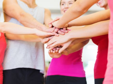 fitness, sport, training, gym, success and lifestyle concept - group of happy people in the gym celebrating victory