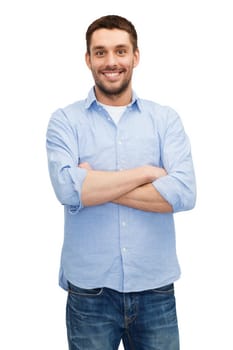 happiness and people concept - smiling man with crossed arms