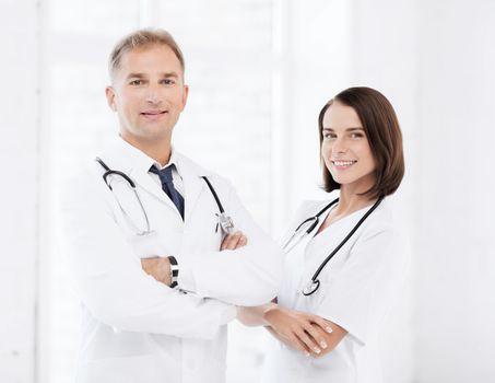 healthcare and medical concept - two doctors with stethoscopes