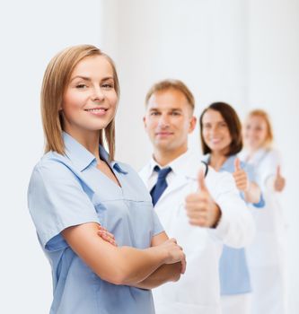 healthcare and medicine concept - smiling female doctor or nurse