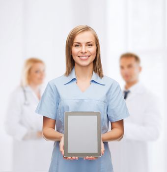 healthcare, technology, advertisement and medicine concept - smiling female doctor or nurse and tablet pc computer with blank screen