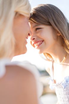 summer holidays, family, children and people concept - happy mother and child girl outdoors