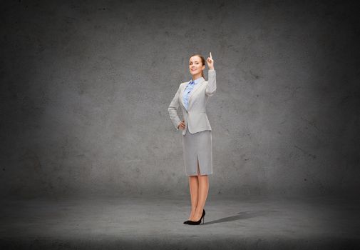 business and education concept - attractive young businesswoman with her finger up