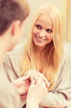 summer holidays, love, travel, tourism, relationship and dating concept - romantic man proposing to beautiful woman