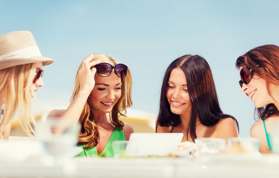 summer holidays, vacation, internet and technology - girls looking at tablet pc in cafe