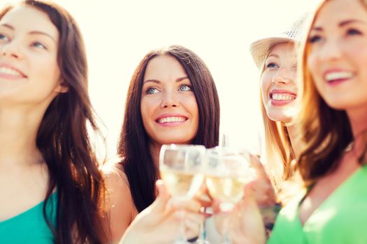 summer holidays, vacation and celebration - girls with champagne glasses