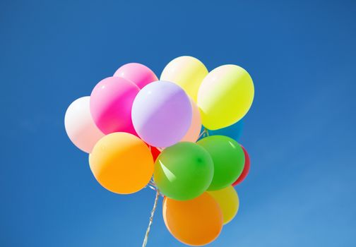 balloons and celebration concept - lots of colorful balloons in the sky