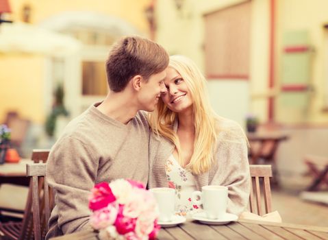 summer holidays, love, travel, tourism, relationship and dating concept - romantic happy couple kissing in the cafe