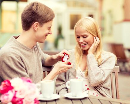 summer holidays, love, travel, tourism, relationship and dating concept - romantic man proposing to beautiful woman