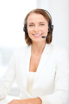 business, communication and call center concept - smiling female helpline operator with headphones in call center