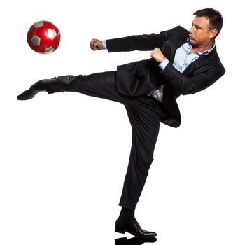 one  business man playing kicking soccer ball in studio isolated on white background