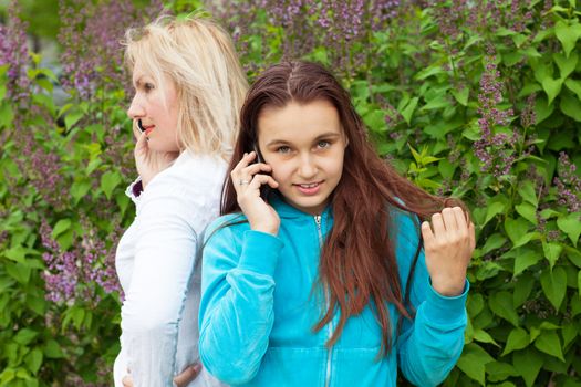 mother and daughter talking by phones